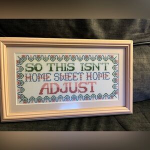 Beautiful cross-stitched picture that is professionally frames.